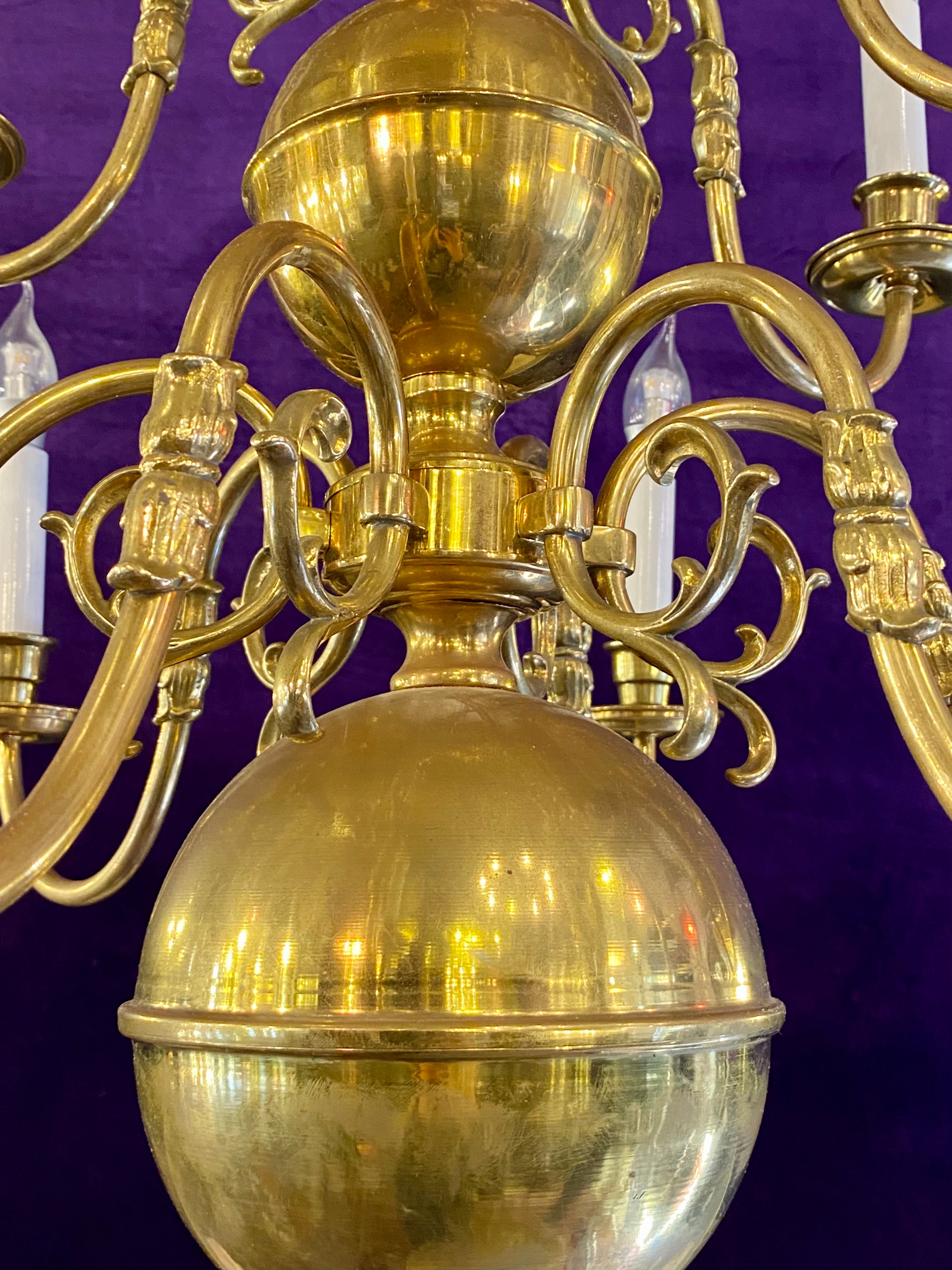 An Antique Polished Brass Double Tier Chandelier